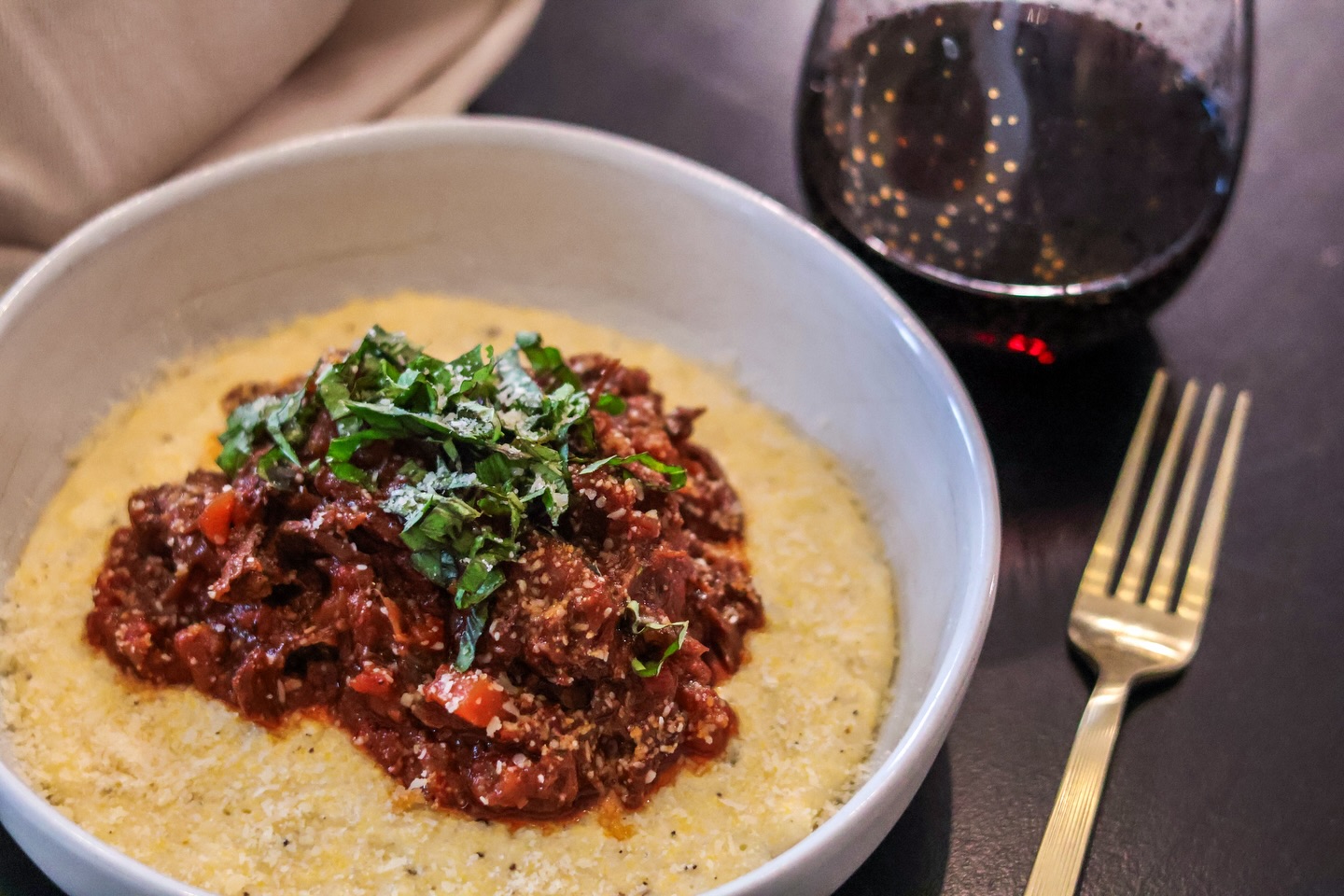 Sunday sauce done right.

Slow braised @snakeriverfarms American Wagyu chuck roast, shredded and piled over a velvety bed of creamy Parmesan polenta. Finished with fresh basil, a glass of red wine, and the kind of comfort food that makes you slow down and savor every bite.

Rustic, rich, and full of deep Sunday flavor.

#TeamSRF #thesrfexperience #wagyu #sauce #sundaysauce